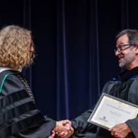 Provost Drake giving Brian Deyo his award
